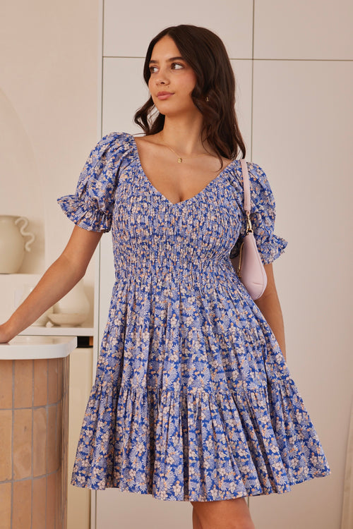 model in blue floral mini dress