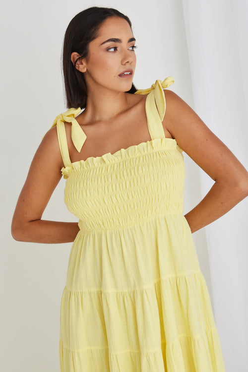 model wearing long yellow maxi dress