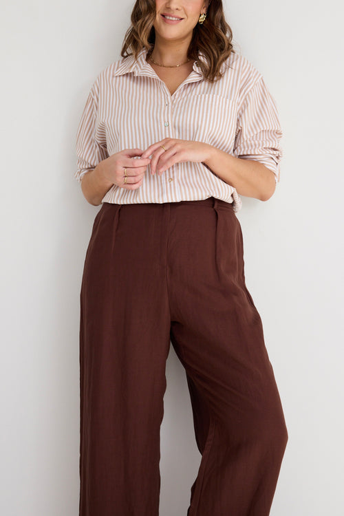 model wears brown linen pants