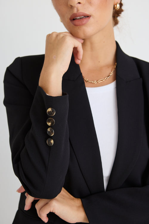 model wears a black blazer