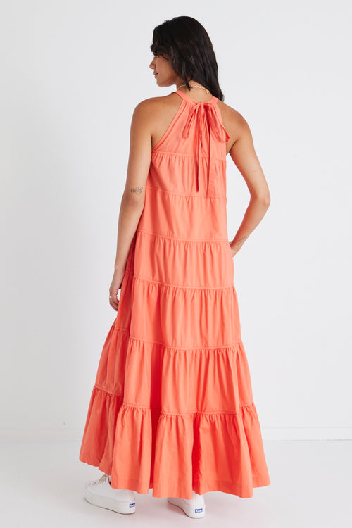 model in orange maxi dress