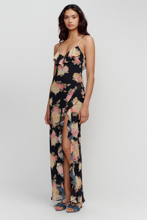 model wears a black floral maxi dress