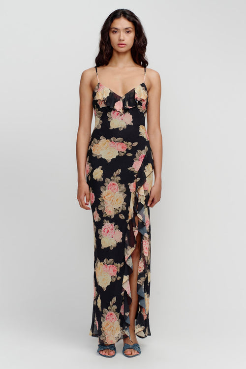 model wears a black floral maxi dress