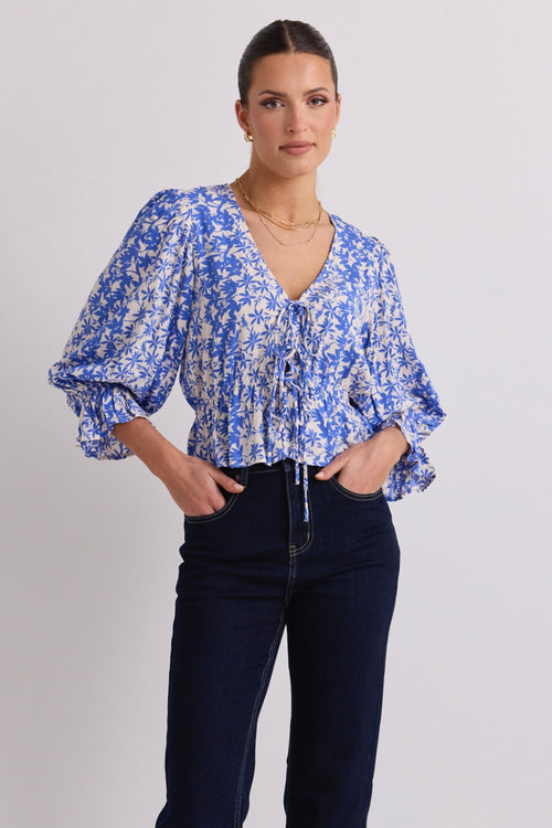 model wears a blue floral top