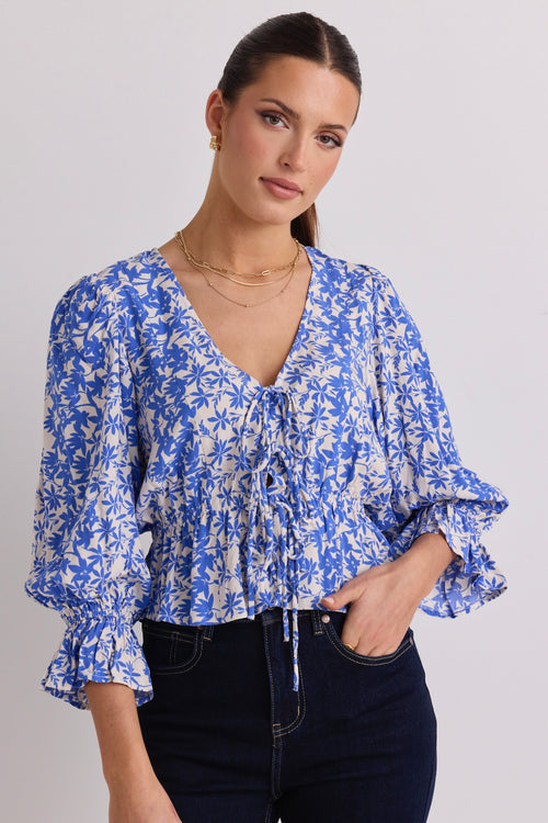 model wears a blue floral top