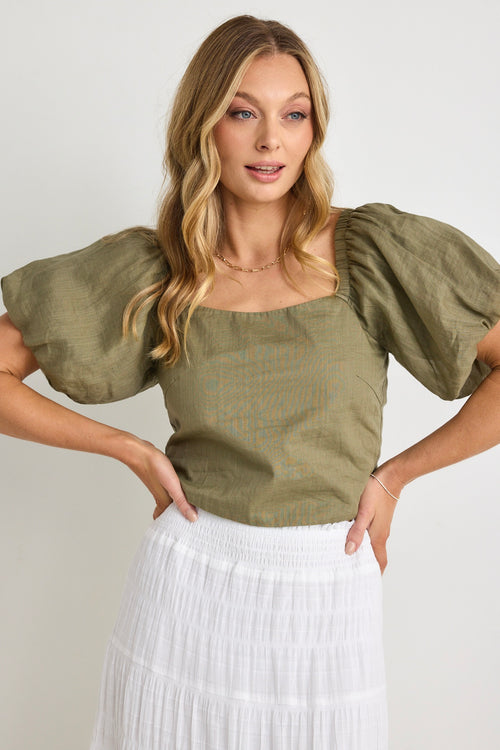 model wears a green linen puff sleeve top