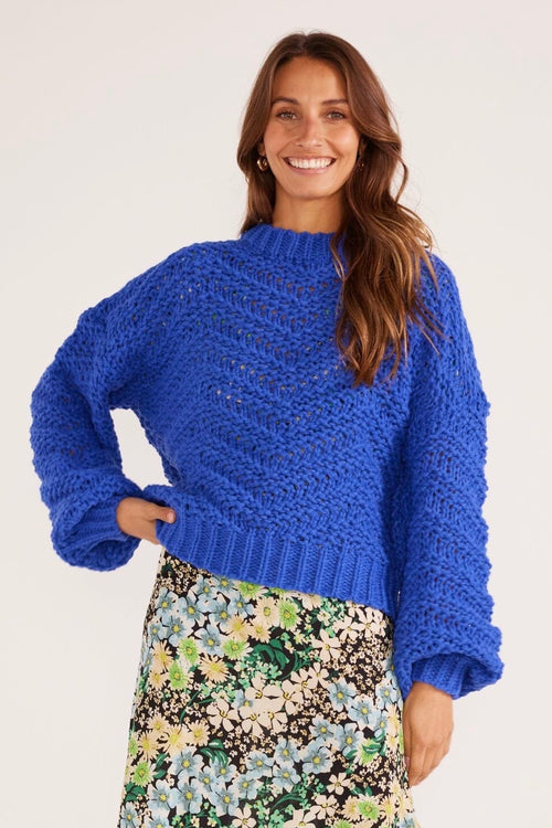 model wears a blue knit