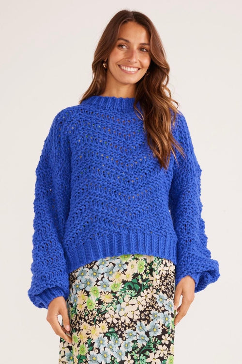 model wears a blue knit