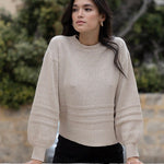 Model wears a beige knit