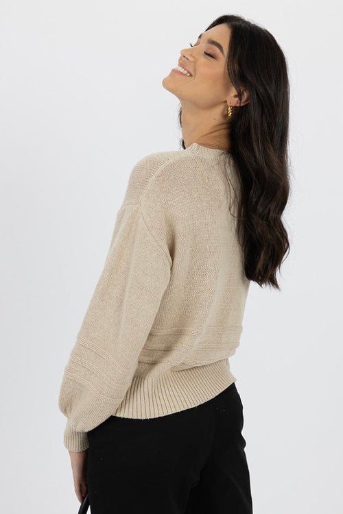 Model wears a beige knit