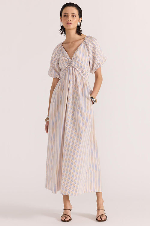 model wears a beige stripe dress