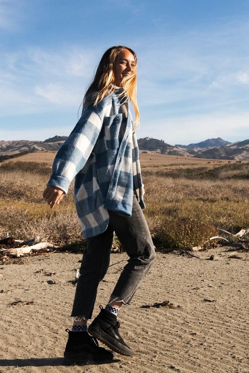 Model wears a blue check jacket