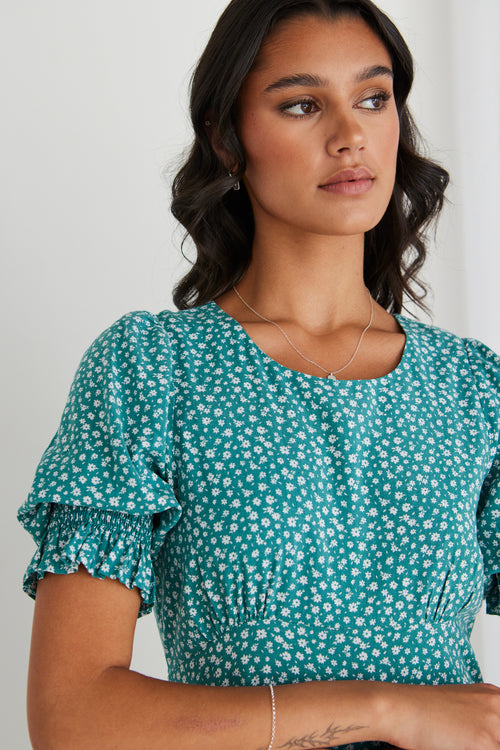 Model wearing long green spotty dress