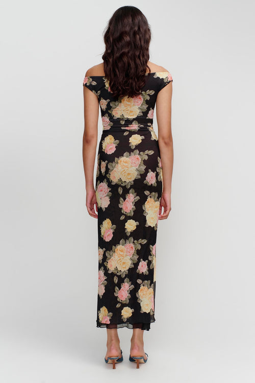 model wears a black floral maxi dress