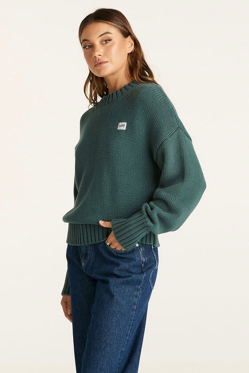 Model wears a Green Knit Sweater 