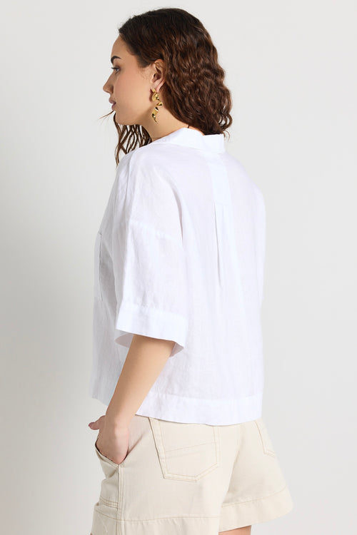 model wears a white linen shirt 