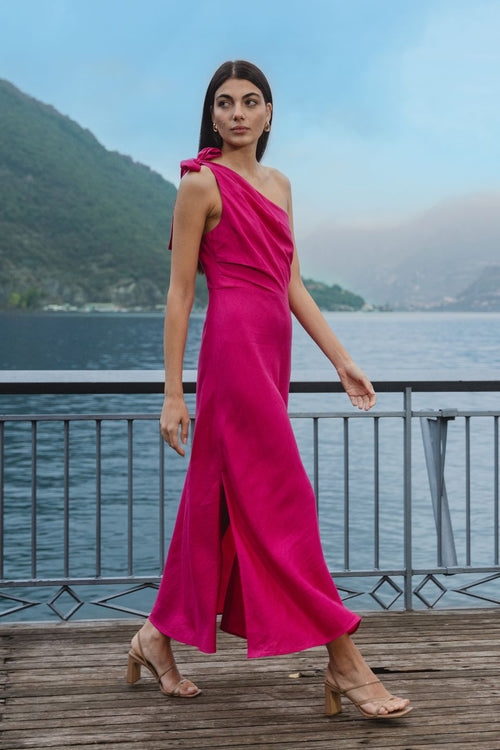 model wears a one shoulder pink midi dress