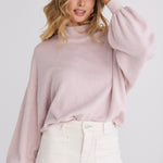 model wears a pink knit