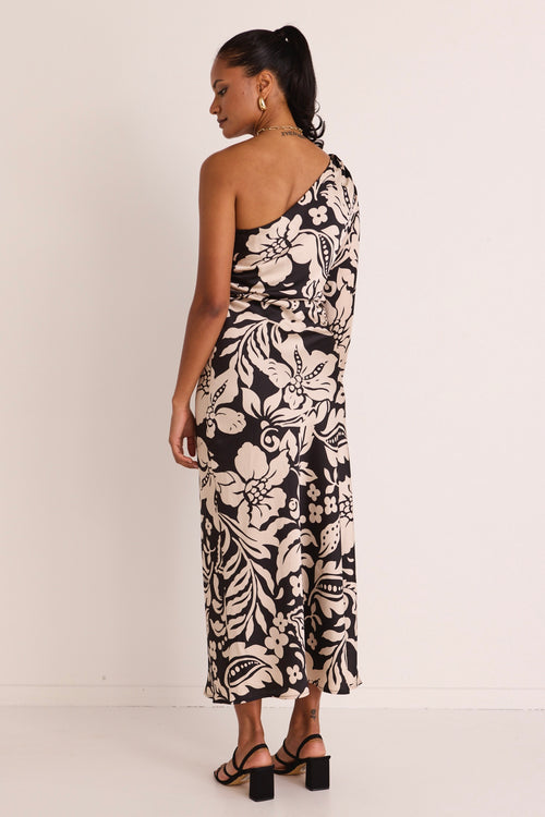 model wears a one shoulder black floral midi dress