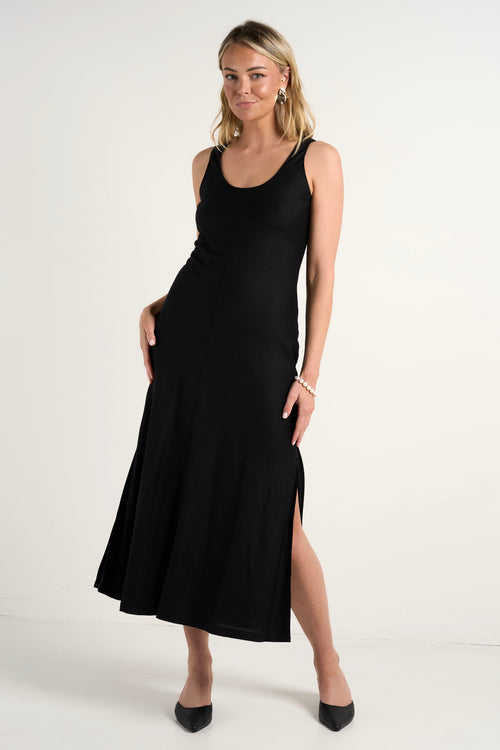 model wears a black linen midi dress