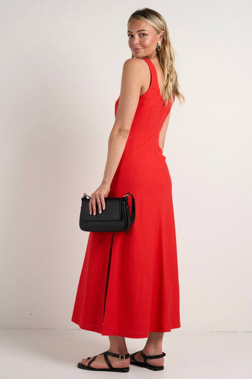 model wears a red linen maxi dress