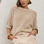 model wears a brown knit top