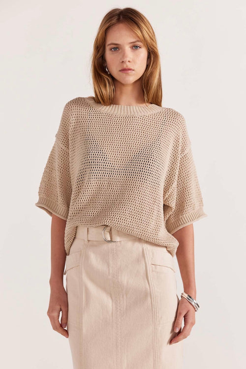 model wears a brown knit top