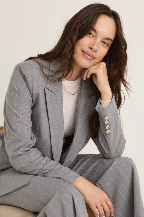 model wears a grey blazer