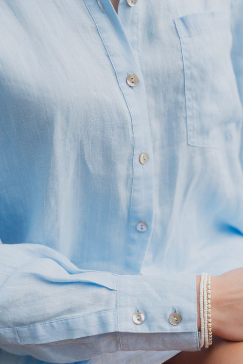 model wears blue oversized shirt