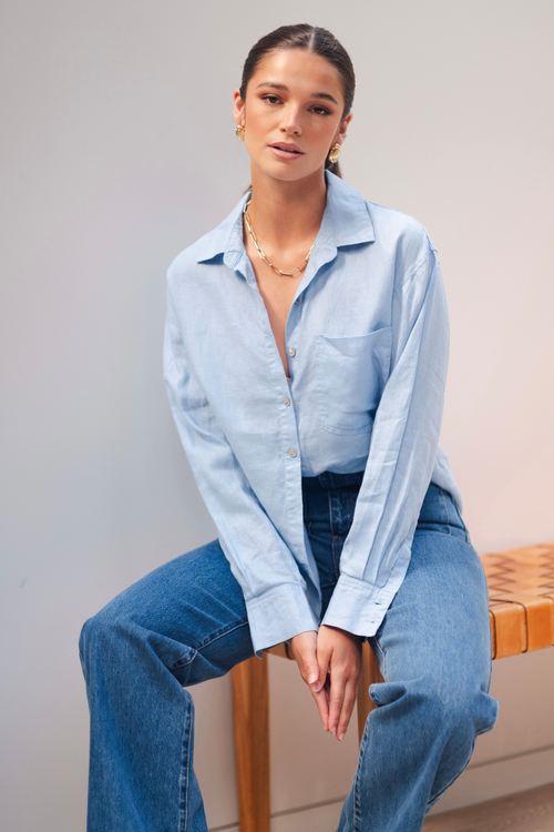 model wears a blue linen shirt