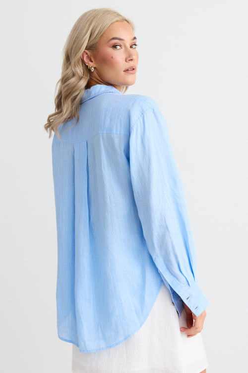 model wears blue oversized shirt