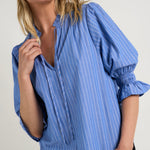 Model wears a blue stripe blouse