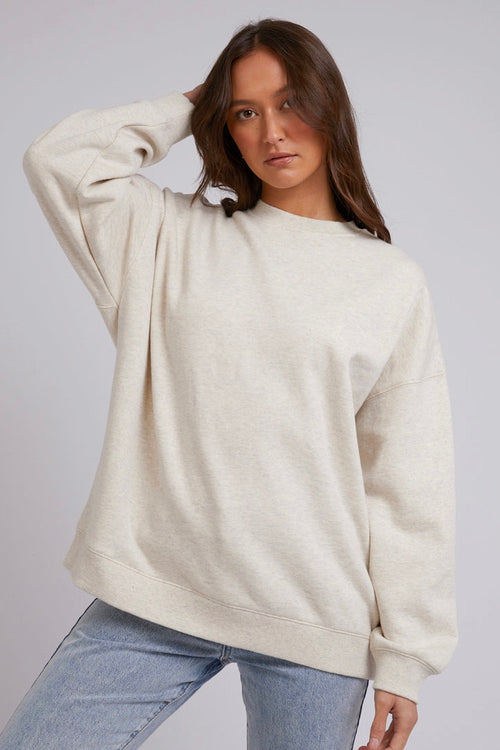 model wears a Beige Jumper with blue jeans