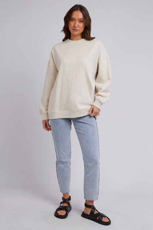 model wears a Beige Jumper with blue jeans