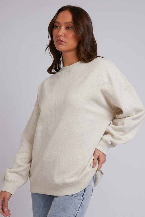 model wears a Beige Jumper with blue jeans