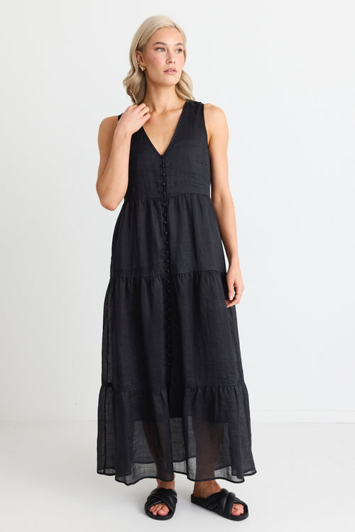 model wears a black maxi dress