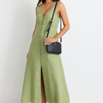 model wears a green linen midi dress