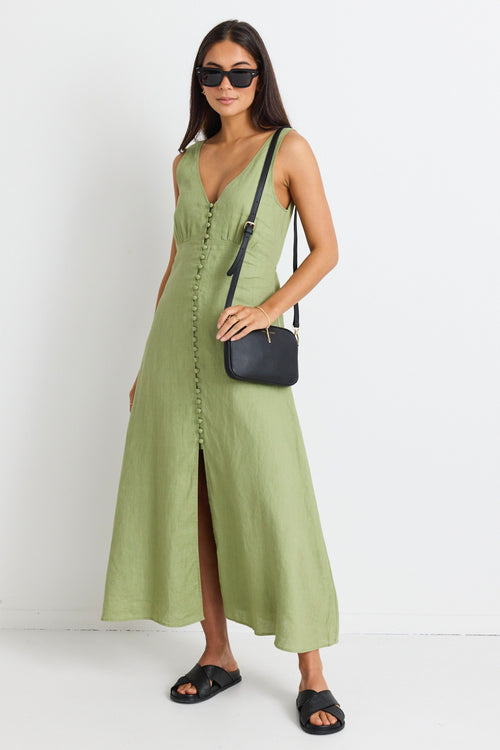 model wears a green linen midi dress