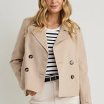 model wears a beige coat