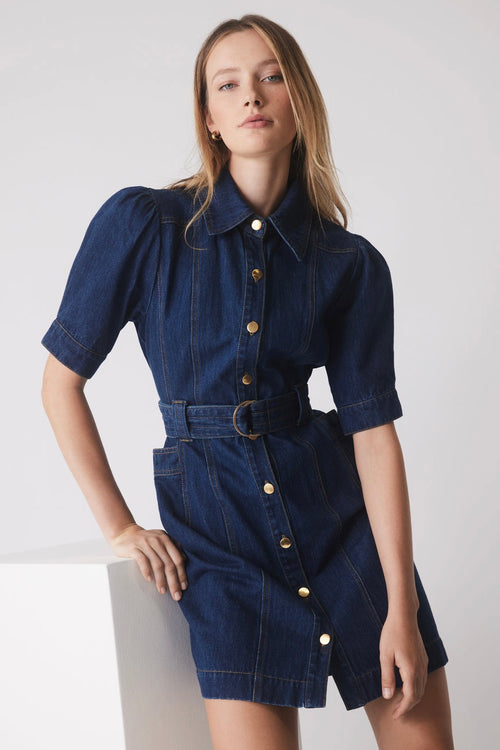 model wears a blue denim mini dress