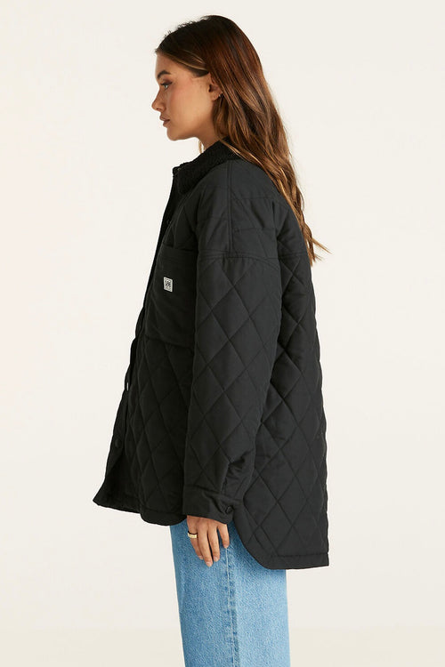 model wears a Black Quilted Jacket