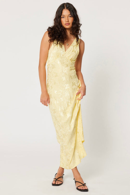 model wears a yellow maxi dress