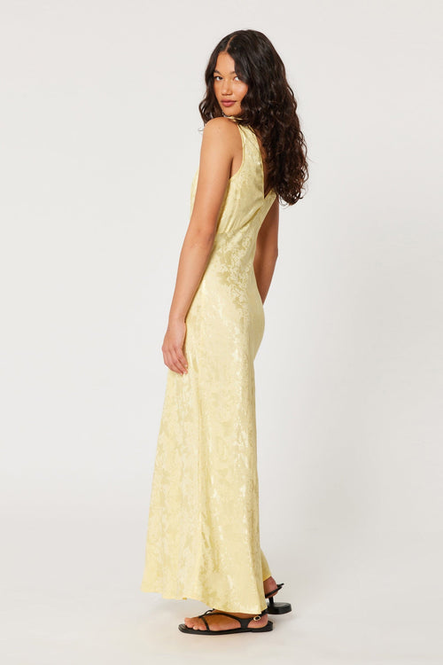 model wears a yellow maxi dress