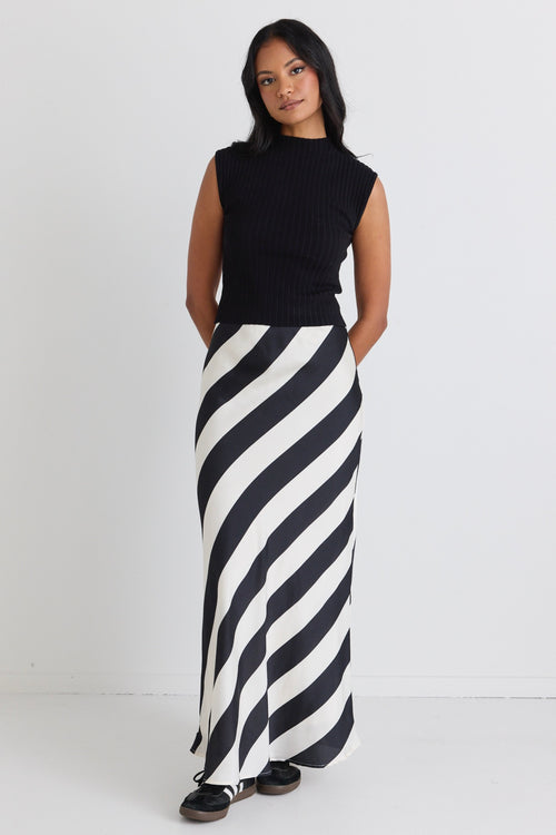 model wears a Black White Stripe Satin Bias Maxi Skirt