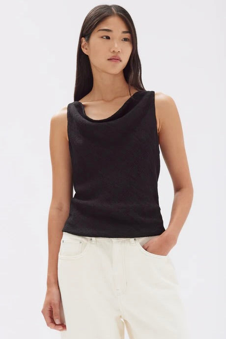 model wears a black cowl neck top