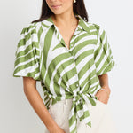 model wears a green and white stripe shirt