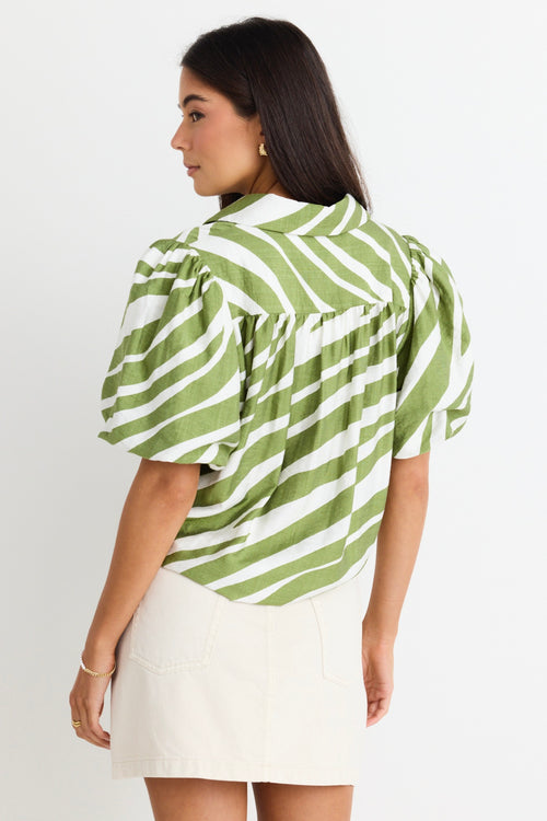 model wears a green and white stripe shirt