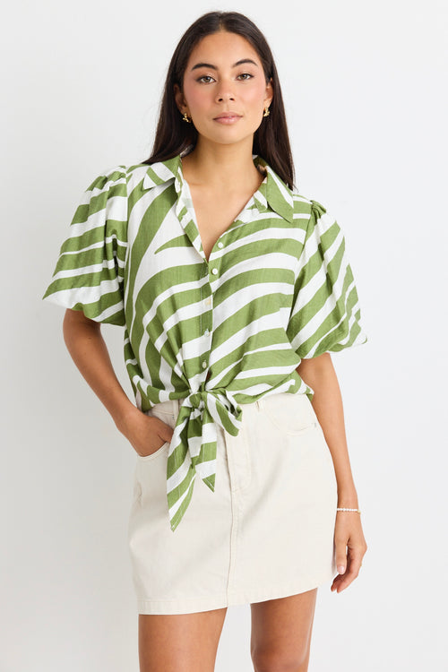 model wears a green and white stripe shirt