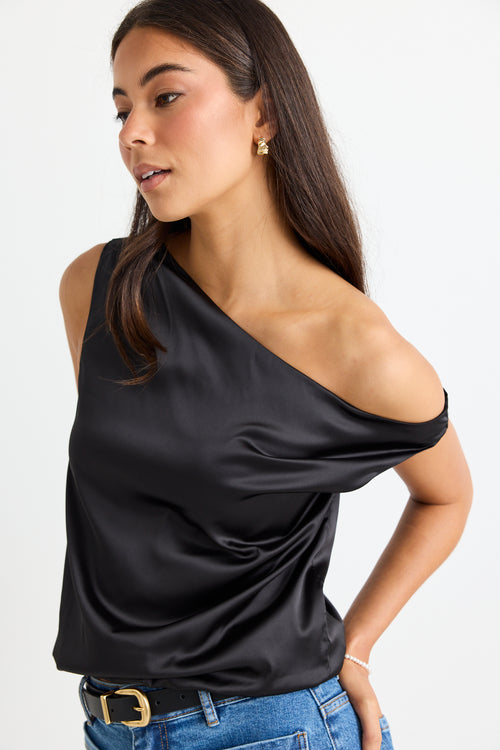 model wears a black satin one shoulder top