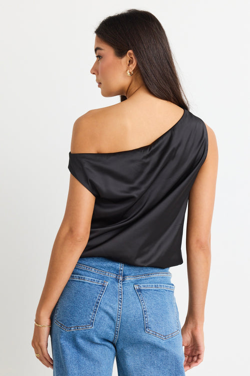 model wears a black satin one shoulder top